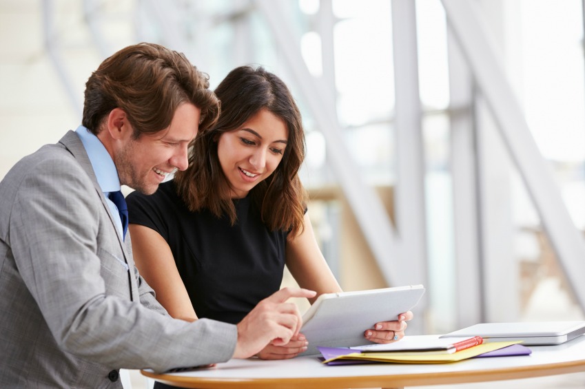 Two corporate business colleagues working together in office